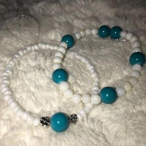 2 Pack white/turquoise bracelets.
